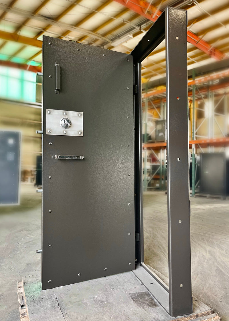 Large brown metal vault door in a warehouse setting