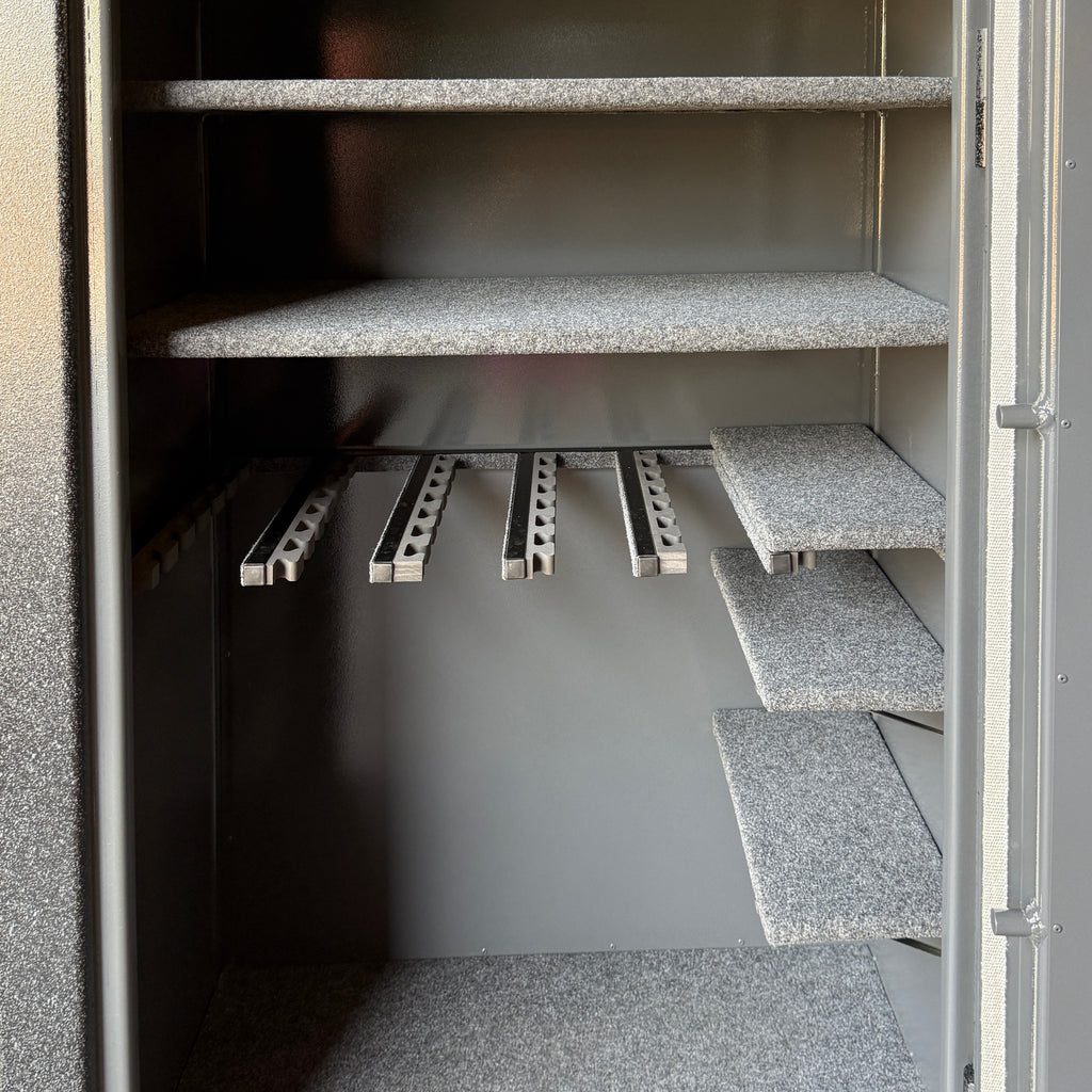 gun safe interior shelving unit with gray shelves and metal gun rack.