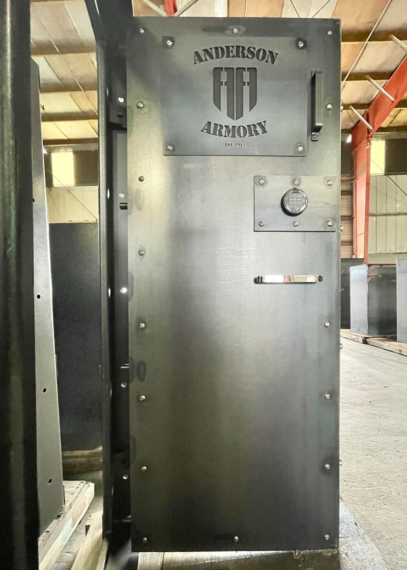 Large metal vault door with 'Anderson Armory' branding in an indoor setting.