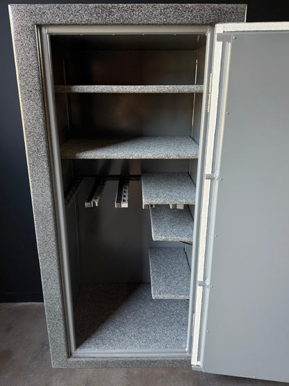 gun safe with open door showing interior shelves against a dark background