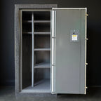Large metal gun safe with open door on a dark background