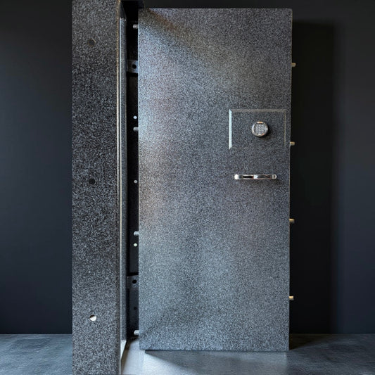 Close-up of the front of a vault door with a textured surface and visible lock mechanism.