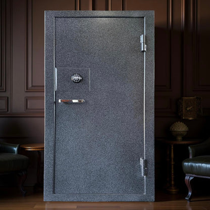 Gray gun safe with a silver handle in a dimly lit room.