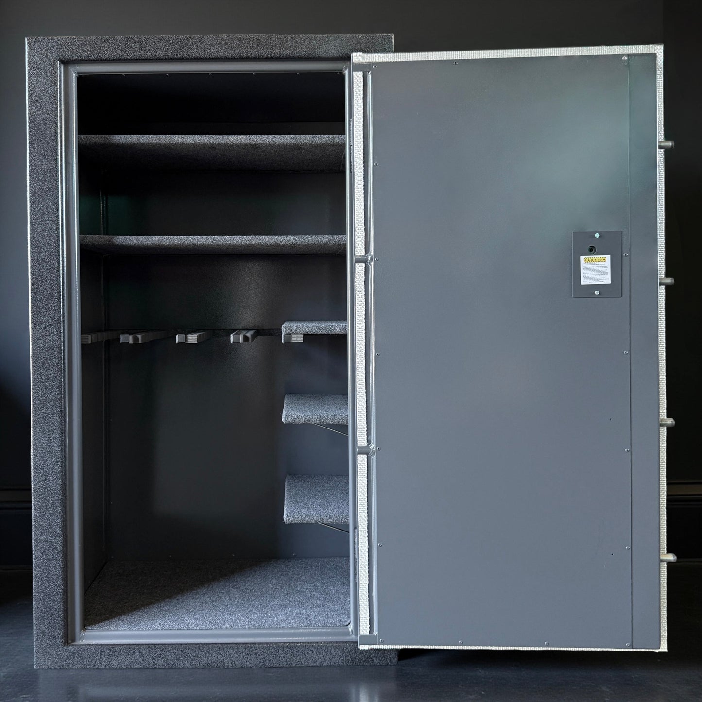 Large metal gun safe with open door on a black background