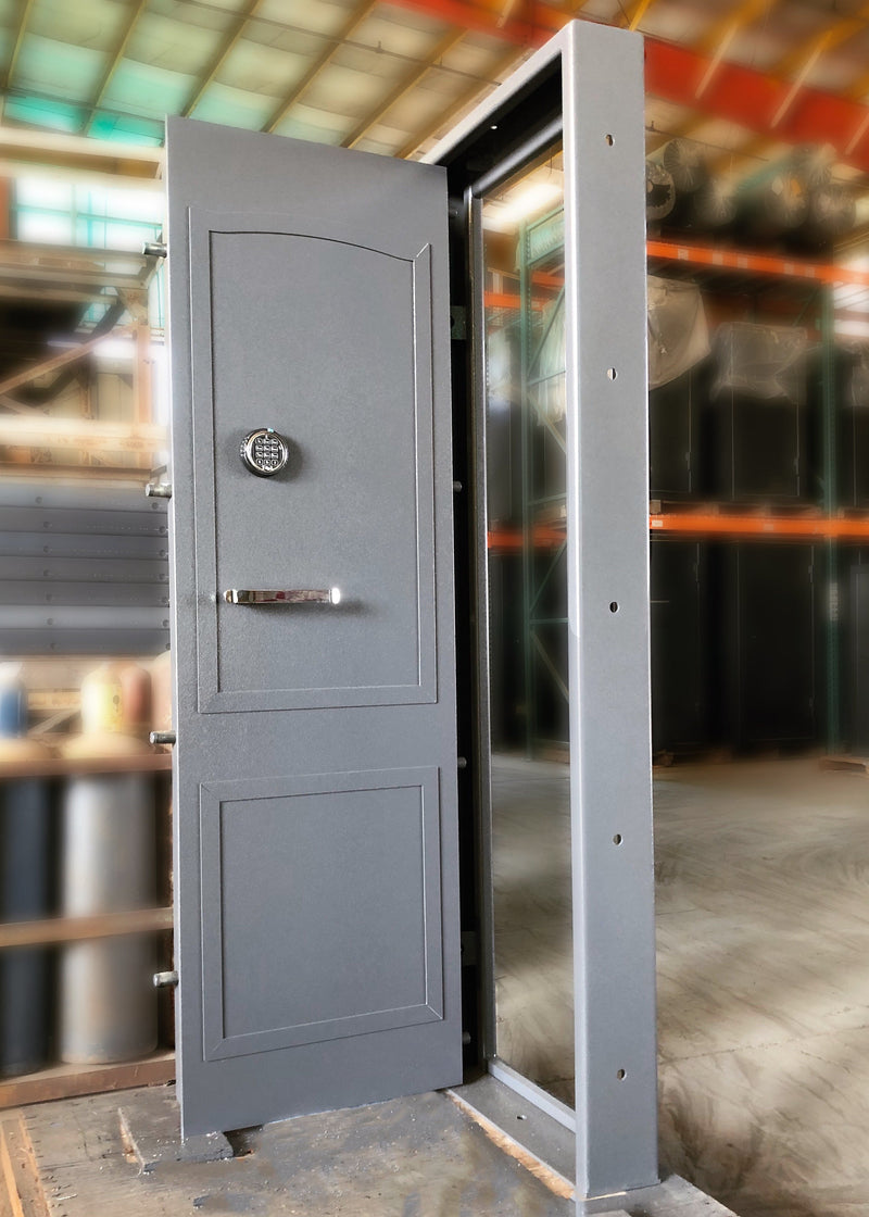 Large gray narrow vault door in an industrial setting