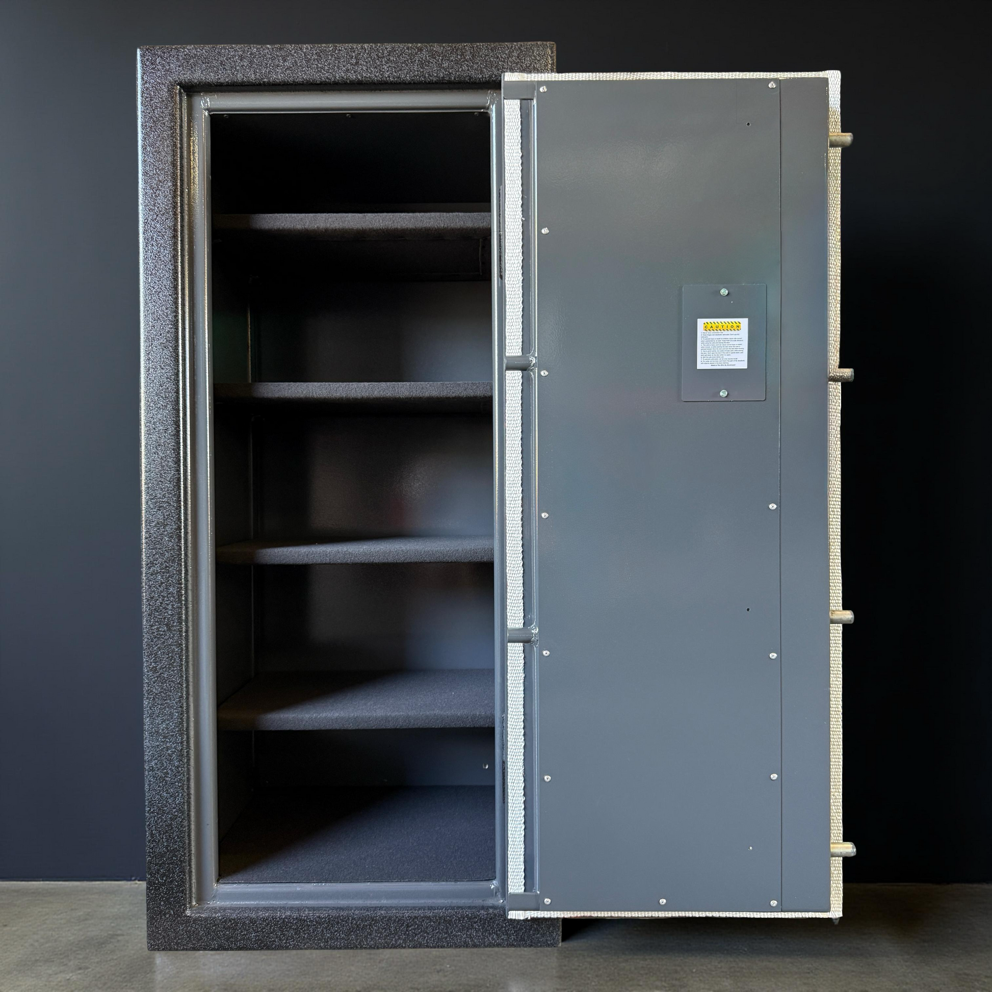 Large metal gun safe with open door on a dark background
