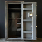 Open gray gun safe with visible interior shelves against a dark background
