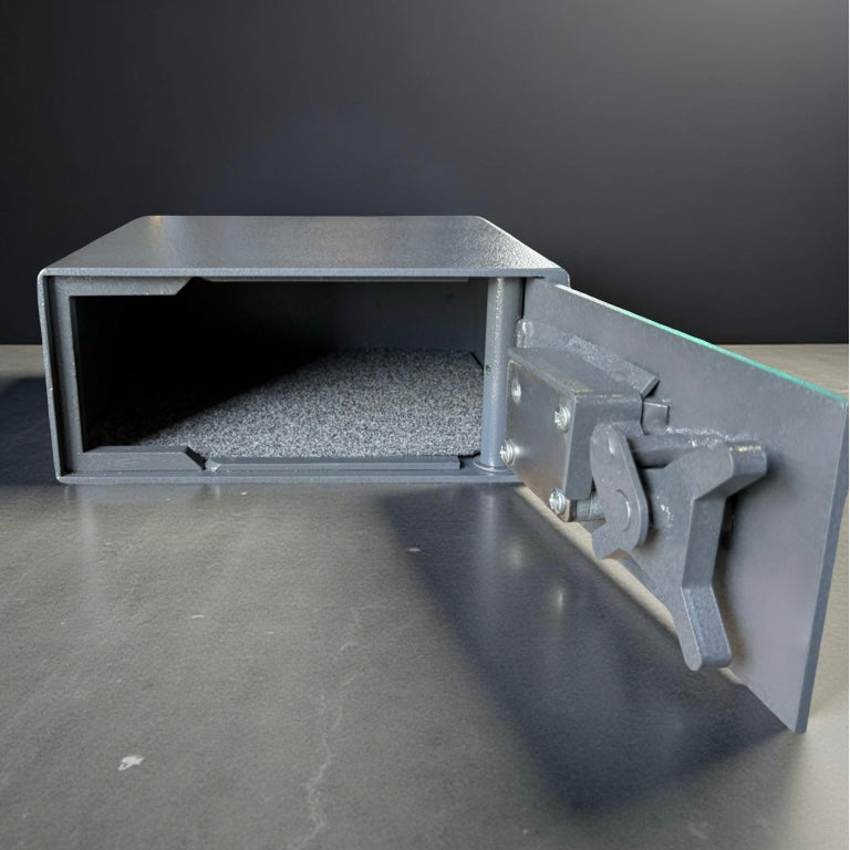pistol safe box with open door on a dark surface
