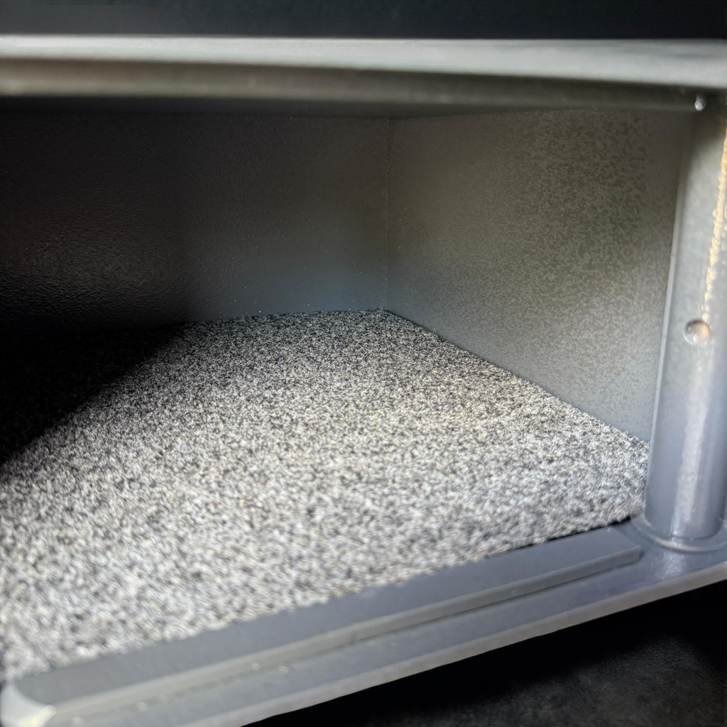 Close-up of a pistol safe box with textured interior