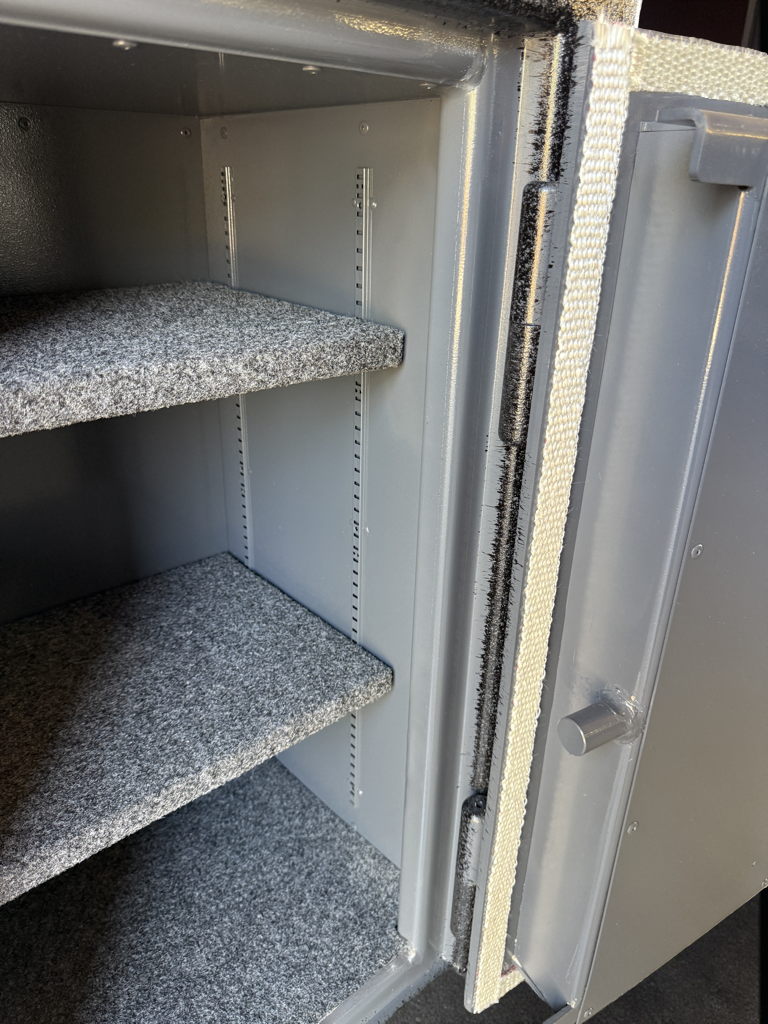 Open pistol safe with shelves inside