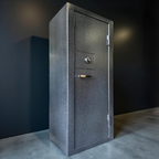 side view of Gray gun safe against a dark wall