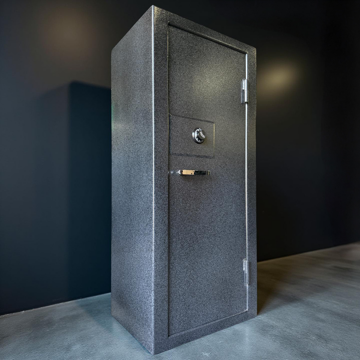 side view of Gray gun safe against a dark wall