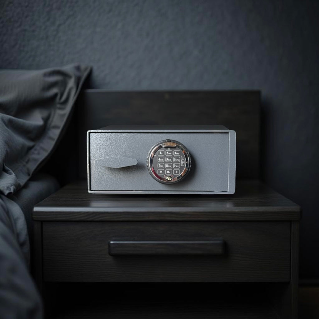 pistol safe box on a wooden nightstand against a dark wall.