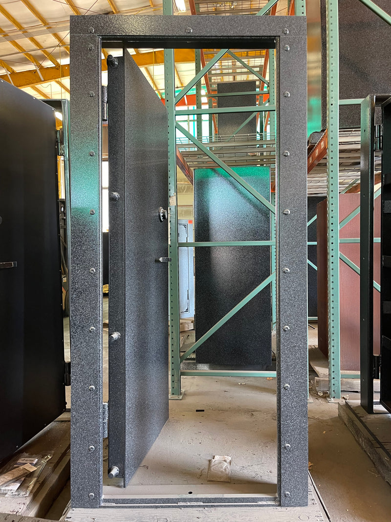Metal vault door frame with a platform inside a construction or warehouse setting