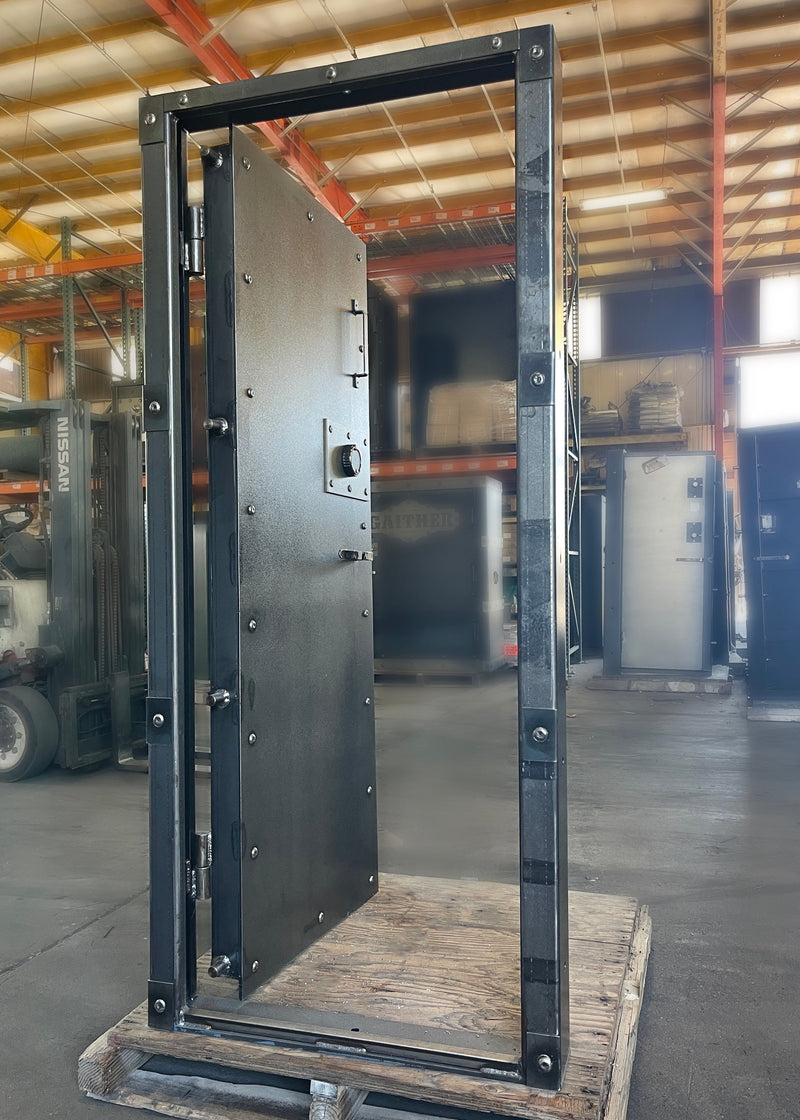 Large metal vault door frame on a pallet in a warehouse setting