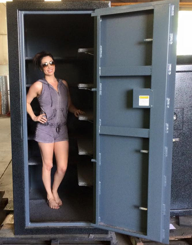 girl standing in a custom size deep gun safe