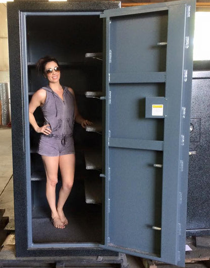 girl standing in a custom size deep gun safe